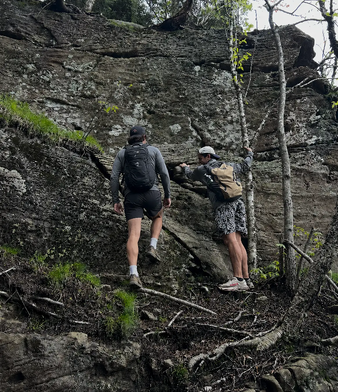 Team scrambling up rock face on Devil's Path